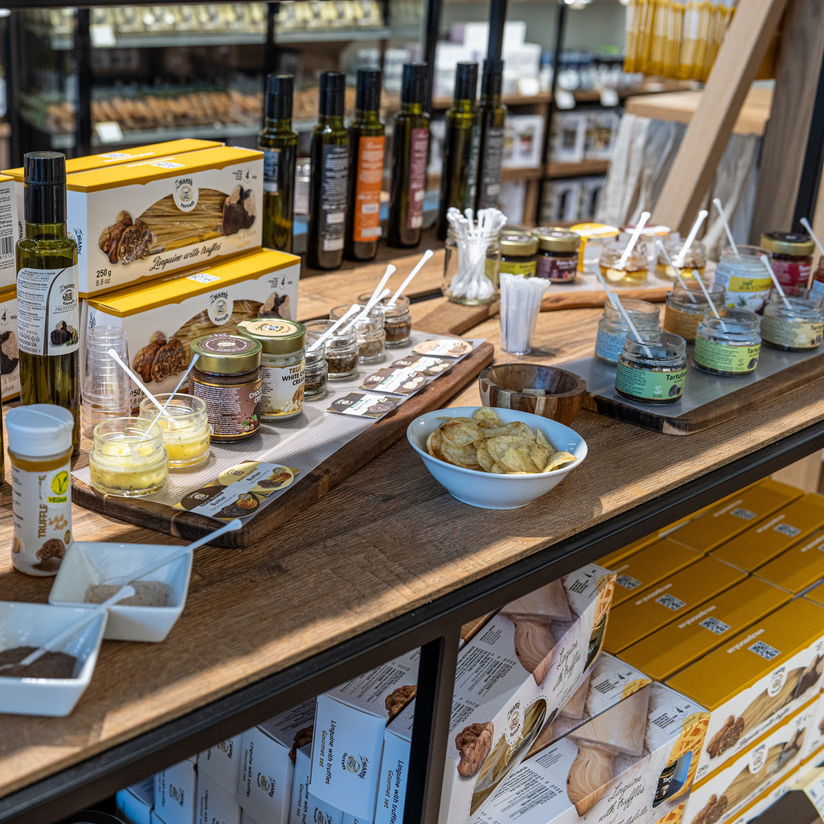 Truffle product tasting counter inside Zigante Tartufi truffle shop in Buje, Istria, Croatia, with oils, sauces, spreads, and samples