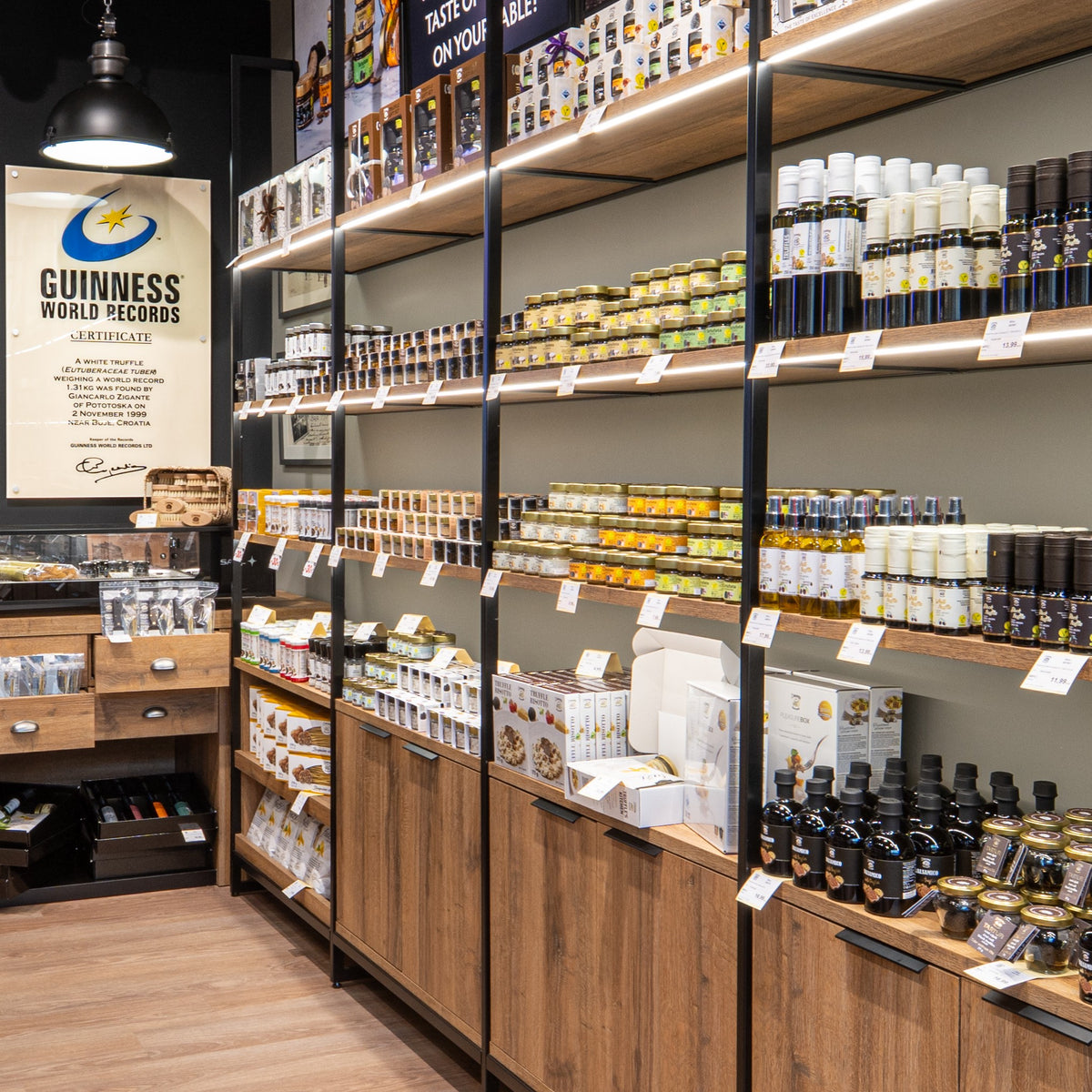 Wall display of truffle oils, sauces, and gourmet products inside Zigante Tartufi truffle shop in Buje, Istria, Croatia