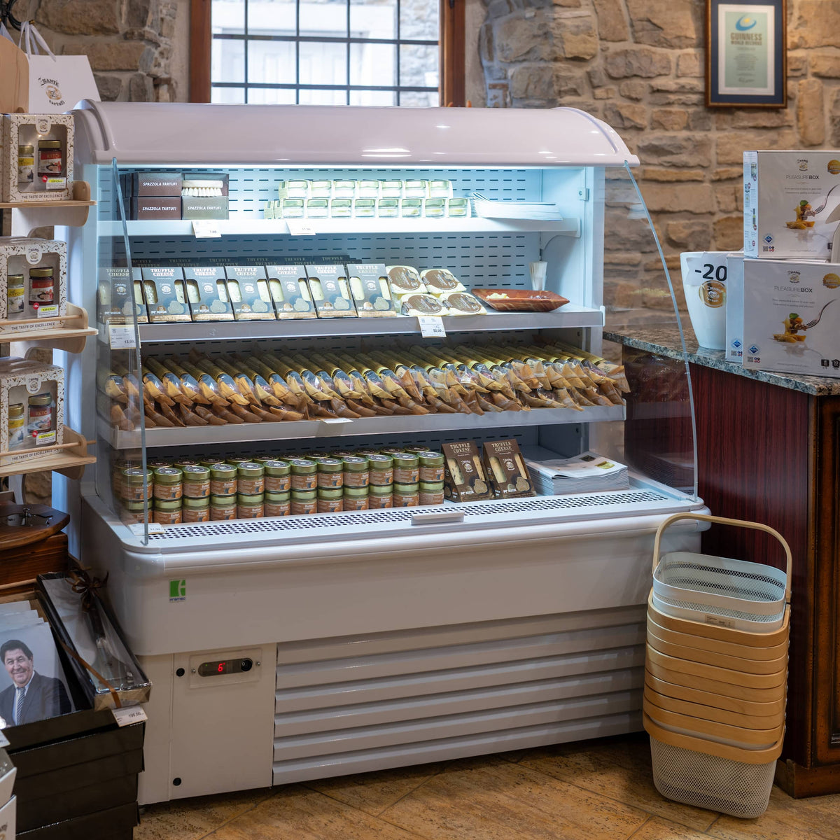 Refrigerated display with truffle cheese, butter and salami at the Zigante shop in Grožnjan