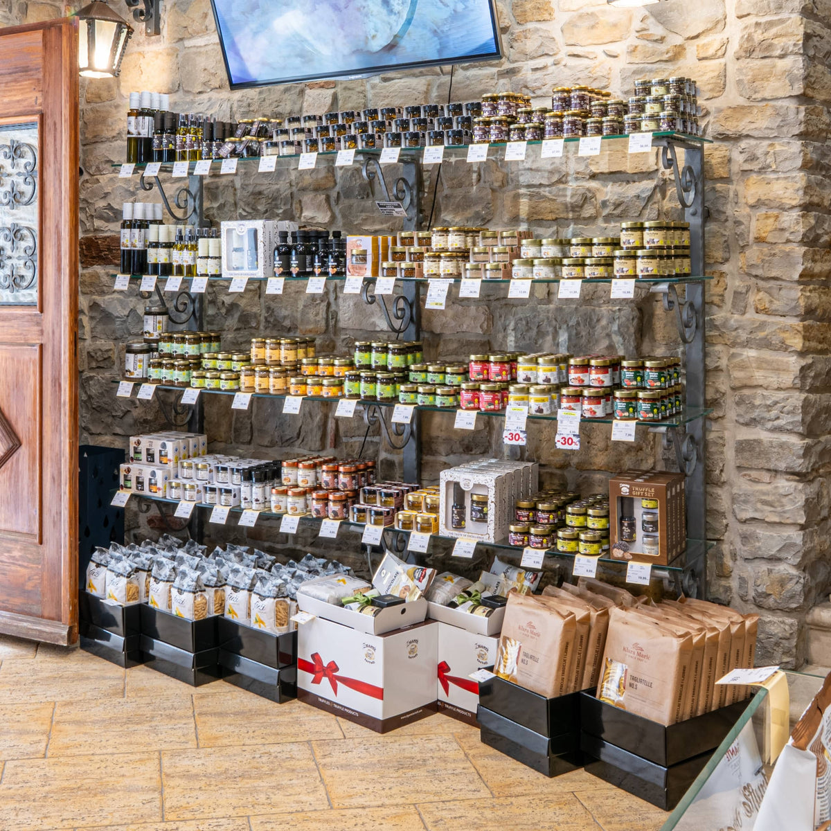 Wall display of truffle oils and sauces in the Zigante Tartufi Grožnjan shop