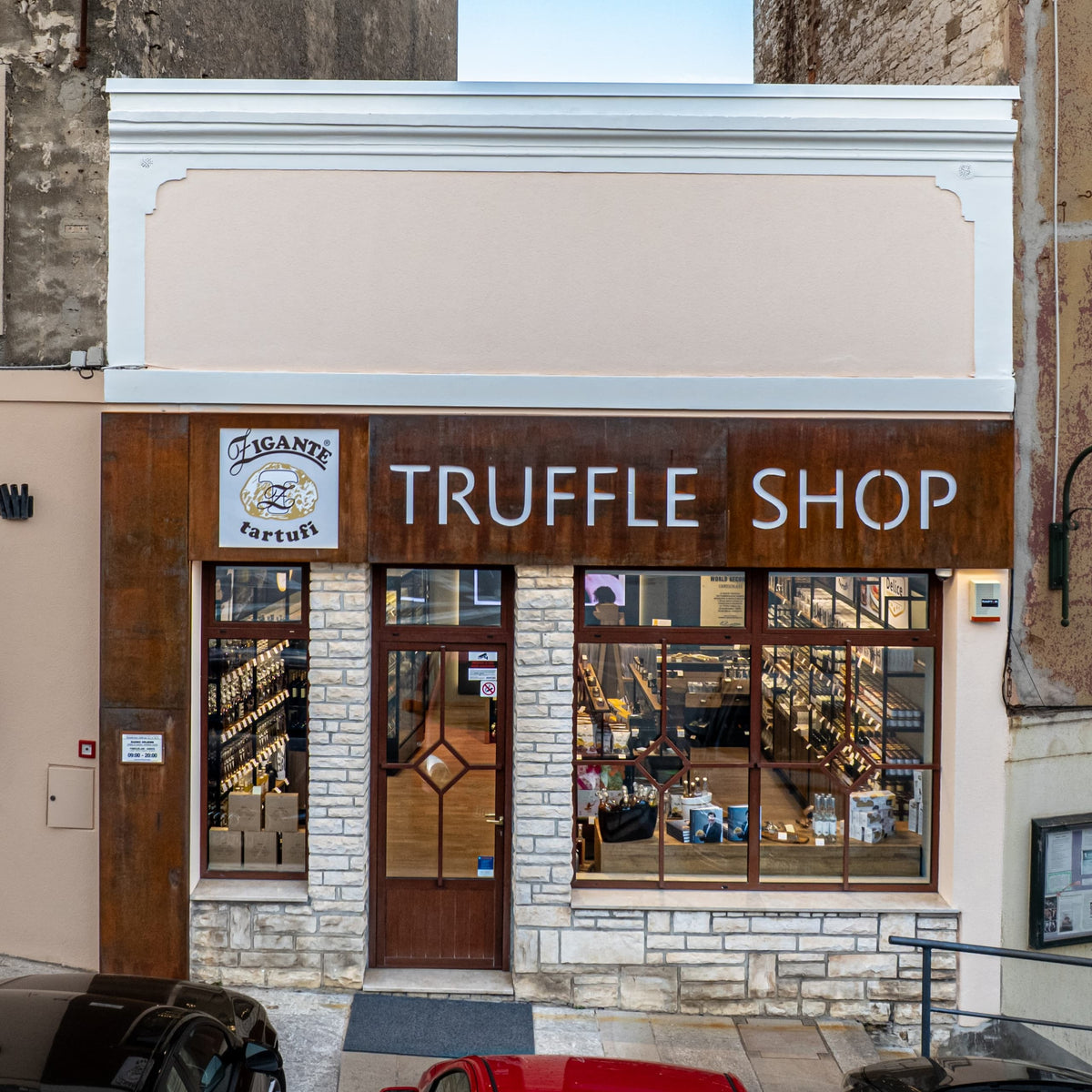 Zigante Tartufi truffle shop storefront in Buje, Istria, Croatia, showing the entrance, logo sign, and product display windows.