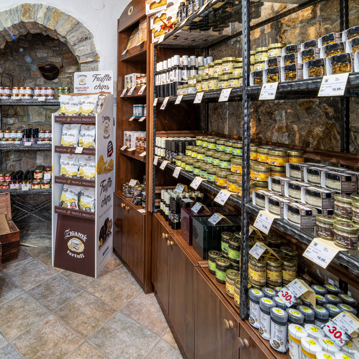 Wall display of truffle oils, sauces, and gourmet products inside Zigante Tartufi truffle shop in Motovun, Istria, Croatia